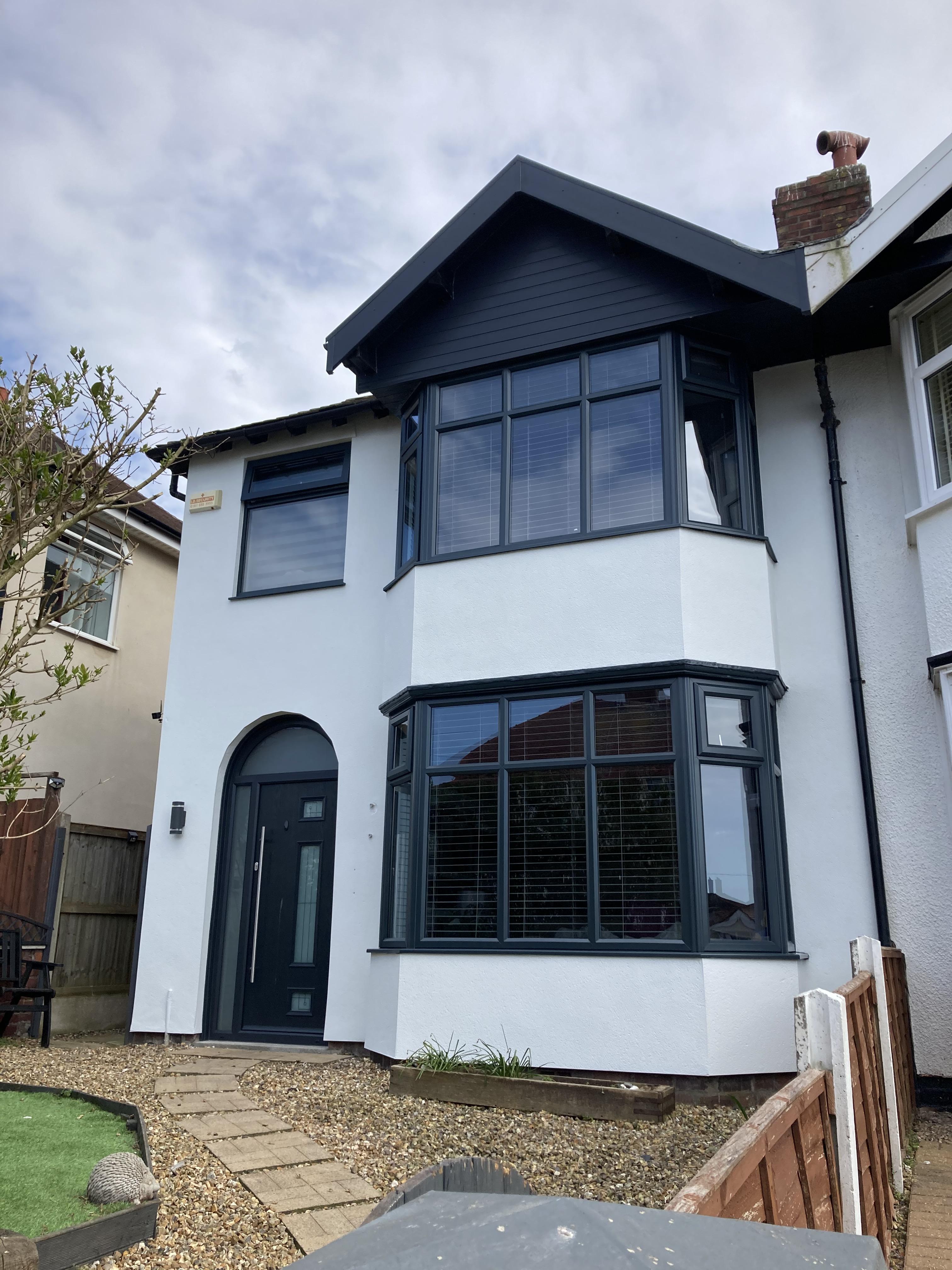 white semi-detached house with anthracite upvc windows and door.